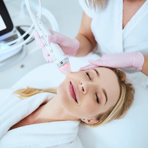 Smiling relaxed woman enjoying the cosmetic procedure